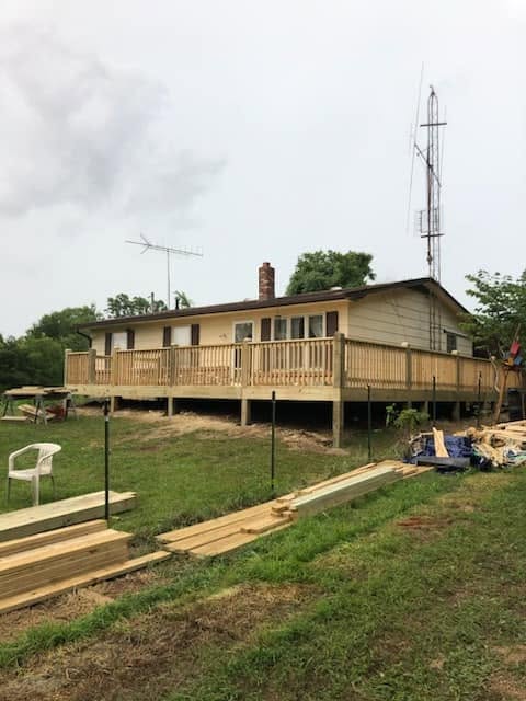 Wooden deck wraparound project at a ranch-style home