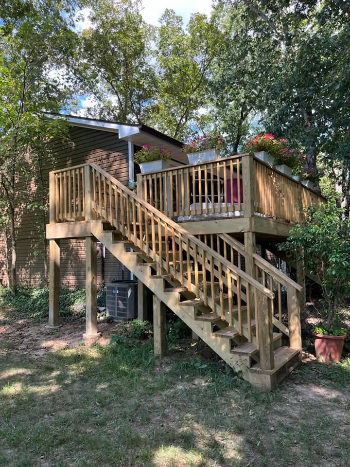 Multi-level wooden deck and stairs with flower planters