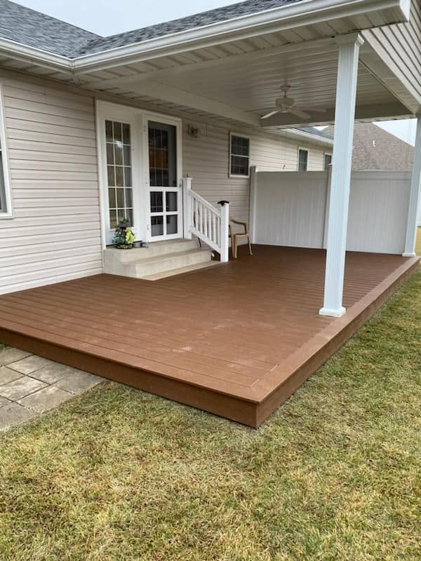 Residential exterior with deck, covered patio, siding, and white fence